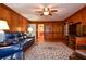 Living room with hardwood floors, a decorative rug, leather furniture, and wood paneling at 5199 Beech Forest Sw Dr, Lilburn, GA 30047