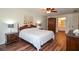 Main bedroom with hardwood floors, ceiling fan, and access to an ensuite bathroom at 5199 Beech Forest Sw Dr, Lilburn, GA 30047