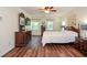 Bright main bedroom with hardwood floors, ceiling fan, and comfortable decor at 5199 Beech Forest Sw Dr, Lilburn, GA 30047
