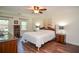 Cozy main bedroom featuring hardwood floors, soft lighting, and a relaxing atmosphere at 5199 Beech Forest Sw Dr, Lilburn, GA 30047