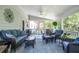 Relaxing screened porch with comfortable seating, ceiling fan, and views of lush greenery at 5199 Beech Forest Sw Dr, Lilburn, GA 30047