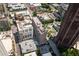 An aerial view showcasing the building's rooftop, a nearby pool, and surrounding streets and urban environment at 620 Peachtree Ne St # 1716, Atlanta, GA 30308