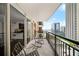 Relaxing balcony with seating and city views of neighboring buildings at 620 Peachtree Ne St # 1716, Atlanta, GA 30308