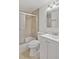 Bathroom with large vanity, tile backsplash, toilet, and shower and bathtub with glass doors at 620 Peachtree Ne St # 1716, Atlanta, GA 30308