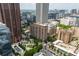 An aerial view of a high-rise building within a bustling city, surrounded by other buildings and greenery at 620 Peachtree Ne St # 1716, Atlanta, GA 30308