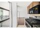 Modern kitchen featuring stainless steel appliances, granite countertops, and balcony view at 620 Peachtree Ne St # 1716, Atlanta, GA 30308