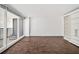 Bright, spacious living room with dark floors, built in shelving, and balcony access with a view at 620 Peachtree Ne St # 1716, Atlanta, GA 30308