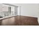 Bright living room with wood floors, natural light, and a balcony with city views at 620 Peachtree Ne St # 1716, Atlanta, GA 30308