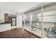 Sunlit living room with balcony access, showcasing open kitchen concept and wood floors at 620 Peachtree Ne St # 1716, Atlanta, GA 30308