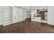 Open-concept living space with hardwood floors, built-in shelving, and kitchen view at 620 Peachtree Ne St # 1716, Atlanta, GA 30308