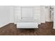Living room with pull down Murphy bed and shelving, allowing it to serve as an extra bedroom at 620 Peachtree Ne St # 1716, Atlanta, GA 30308