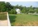 Expansive backyard with lush green grass and a wooden fence surrounding the property, viewed from the deck at 230 Happy Valley Church Rd, Dallas, GA 30157