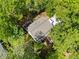 Aerial view of a well-maintained home with a brown roof and surrounded by green trees at 3306 Emory Dr, Marietta, GA 30062