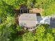Aerial view of a cozy home featuring a charming deck and driveway, all nestled among trees at 3306 Emory Dr, Marietta, GA 30062