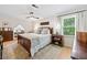 Well-lit bedroom featuring a queen-sized bed, a ceiling fan, and built-in storage shelves in alcove at 3306 Emory Dr, Marietta, GA 30062