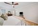 Bedroom with a ceiling fan, hardwood floors, neutral walls, a TV on a stand, and natural light from a window at 3306 Emory Dr, Marietta, GA 30062