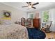 Bright bedroom featuring wood floors, a crib, rocking chair, dresser, and patterned bedding at 3306 Emory Dr, Marietta, GA 30062