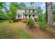 Charming two-story home with a brick foundation, a well-manicured lawn, and mature trees at 3306 Emory Dr, Marietta, GA 30062