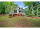 Charming two-story home with a brick foundation and inviting front porch nestled amongst mature trees at 3306 Emory Dr, Marietta, GA 30062
