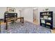 Spacious home office with hardwood floors, built-in bookshelves, large decorative rug, and adjacent staircase at 3306 Emory Dr, Marietta, GA 30062