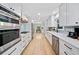 Beautiful galley kitchen with stainless steel appliances, quartz countertops, and sleek white cabinetry at 3306 Emory Dr, Marietta, GA 30062