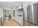 Kitchen featuring stainless steel appliances, white cabinets, gas cooktop, and view to dining area at 3306 Emory Dr, Marietta, GA 30062