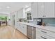 Bright kitchen featuring white cabinets, stainless steel appliances, and a window over the sink at 3306 Emory Dr, Marietta, GA 30062