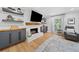 Modern living room with white brick fireplace, floating shelves, and gray cabinetry for a stylish touch at 3306 Emory Dr, Marietta, GA 30062
