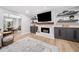 Elegant living room with a fireplace, sleek shelving, and an open view to the dining area at 3306 Emory Dr, Marietta, GA 30062