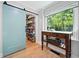 Walk-in pantry with sliding barn door and window overlooking wooded yard at 3306 Emory Dr, Marietta, GA 30062
