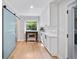 Pantry area with blue sliding barn door, window, and custom cabinets at 3306 Emory Dr, Marietta, GA 30062