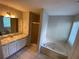 Bathroom with a tub and shower and a vanity with generous counter space at 50 Glenmore Dr, Kingston, GA 30145