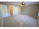 Spacious bedroom featuring neutral walls, tile flooring, and a ceiling fan with lighting at 50 Glenmore Dr, Kingston, GA 30145