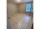 Cozy bedroom with tile floors and a window providing natural light at 50 Glenmore Dr, Kingston, GA 30145
