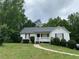 Charming single-story home with a well-maintained lawn and inviting front porch at 50 Glenmore Dr, Kingston, GA 30145
