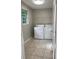 Functional laundry room with washer, dryer, and practical tile flooring at 50 Glenmore Dr, Kingston, GA 30145