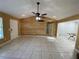 Spacious living room featuring tile flooring, ceiling fan, and a unique decorative wall at 50 Glenmore Dr, Kingston, GA 30145