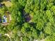 An aerial perspective showing the house and its heavily wooded lot at 5800 Mitchell Rd, Atlanta, GA 30328