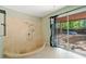 This unique bathroom features a custom tiled shower stall and glass doors to the pool at 5800 Mitchell Rd, Atlanta, GA 30328