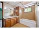 Bathroom with tub and shower, retro tile walls, and wood vanity at 5800 Mitchell Rd, Atlanta, GA 30328