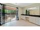 Bathroom with double sinks, granite countertop, and sliding glass doors to the yard at 5800 Mitchell Rd, Atlanta, GA 30328