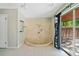A unique bathroom features a custom tiled shower stall and glass doors to the yard at 5800 Mitchell Rd, Atlanta, GA 30328