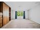A bright bedroom offers a large window, built in shelves and drawers, and plush carpet at 5800 Mitchell Rd, Atlanta, GA 30328
