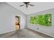 Bedroom with large windows with a view of mature trees, light walls, and a ceiling fan at 5800 Mitchell Rd, Atlanta, GA 30328