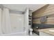 Bathroom featuring a shower/tub, vanity, modern fixtures and wood accent wall at 6851 Roswell Rd # K-23, Atlanta, GA 30328