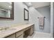 Bright bathroom with double sink vanity, granite countertop, framed mirrors and tile shower at 6851 Roswell Rd # K-23, Atlanta, GA 30328
