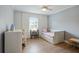 bedroom with bright walls, ceiling fan, ample natural light and a fun, playful unicorn decor at 6851 Roswell Rd # K-23, Atlanta, GA 30328