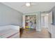 bedroom featuring light blue walls, ceiling fan, and built-in shelving and closet at 6851 Roswell Rd # K-23, Atlanta, GA 30328