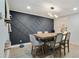Dining area with modern lighting, an accent wall and light wood-look flooring at 6851 Roswell Rd # K-23, Atlanta, GA 30328
