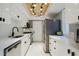 Bright kitchen featuring white cabinets, modern appliances, and unique wood and light fixture on the ceiling at 6851 Roswell Rd # K-23, Atlanta, GA 30328